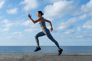 Fototapeta premium athletic brunette girl doing fitness doing exercises leading a healthy lifestyle