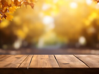 Empty wooden table with blurred bokeh autumn leaves background. Thanksgiving and autumn concept