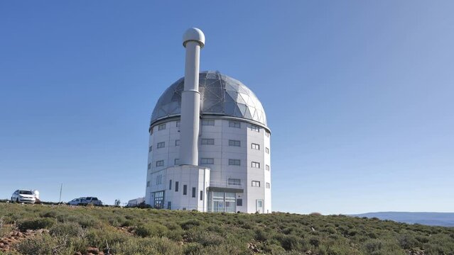 SALT telescope on Karoo hilltop near Sutherland. Shiny domed roof rotates against cloudless blue sky