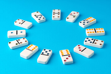 Domino tiles on blue background studio shot