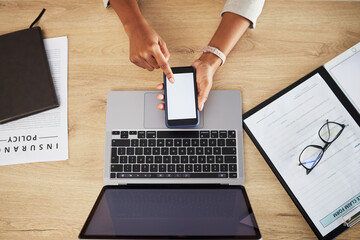 Person hands, blank phone screen and office with mockup space and insurance worker at desk. Mobile app, scroll and top view with web research and business work with data and digital paperwork
