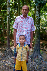 Portrait of south asian rural father and son in outdoor natural environment 