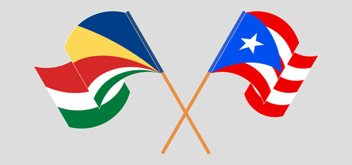 Crossed and waving flags of Seychelles and Puerto Rico