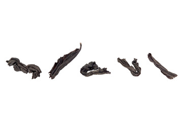 Set of dry black tea leaves isolated on a transparent background.