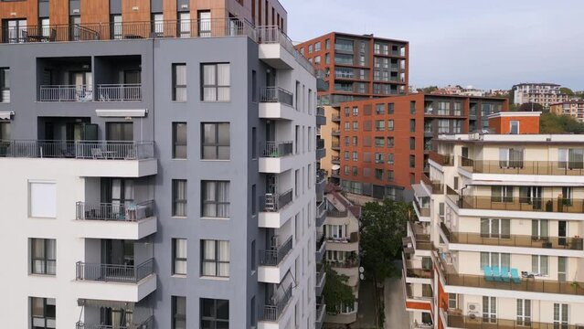 Aerial view of a drone flying around and along the facade of a modern residential building