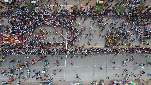 Birds eye view of huge crowd moving on busy roads during immersion of lord ganesha