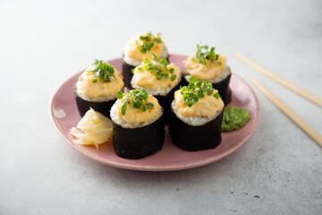 Homemade sushi rolls with roe topping