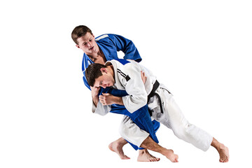 Karate fight. Two karate fighters i white and blue kimono training isolated on transparent...