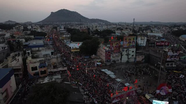 Aerial top view of massive crowd gathered on the city street for a Hindu festival