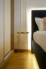 Simple, modern bedroom - King size bed with hidden LED lighting underneath and elegant bedside table