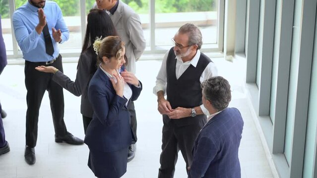 group of diverse business team building standing and talking and introduce yourself after meeting in seminar conference . Multicultural business people discussing or having a conversation