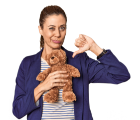 Entrepreneur with plush toy, toy industry theme showing a dislike gesture, thumbs down. Disagreement concept.