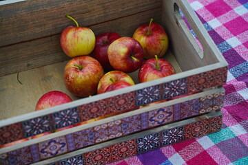 Fresh apples in a wooden basket.