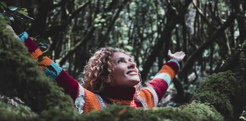 Profile of a relaxed woman breathing fresh air in a green forest. Female people and happiness. Celebrating nature and forest woods travel destination. Wellbeing healthy lifestyle. Overjoy female adult