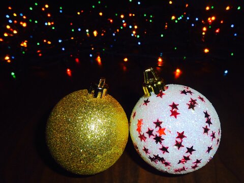 Glitter Christmas baubles with colorful lights in the dark background 