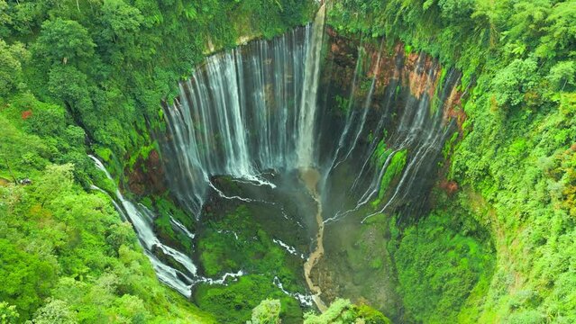 Aerial top view powerful Tumpak Sewu waterfall located in Lumajang, East Java, Indonesia.