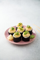 Homemade sushi rolls with roe topping