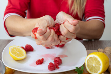 close up of hands squeeze fruit