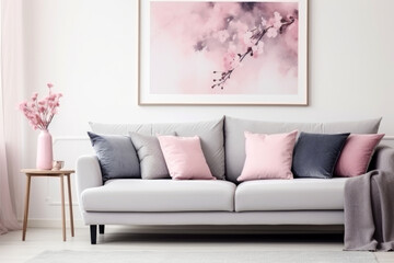 Fototapeta na wymiar Grey sofa with pink pillows and blanket against white wall with abstract art poster. Interior design of modern living room