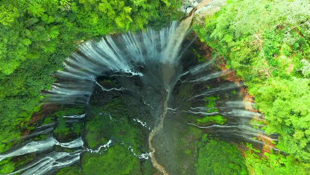 Aerial top view powerful Tumpak Sewu waterfall located in Lumajang, East Java, Indonesia.