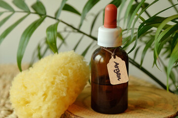 Argan oil in amber glass bottle with natural sea sponge - Natural beauty cosmetics