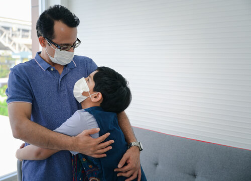 Indian father help his son wearing medical mask to protect Coronavirus covid-19 infected and he teach his son for the method to complete wearing the medical mask.
