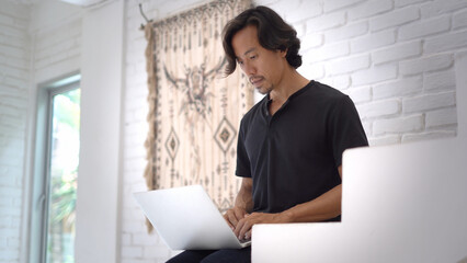 Asian freelancer sit distant work home office covid 19. Business man typing on laptop. Expert...
