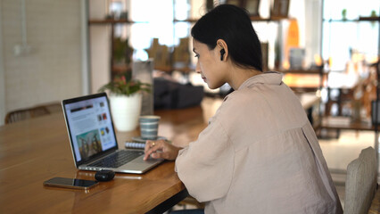 Asian freelancer office cafe. Busy person use computer macbook coworking place. Boss woman looking screen monitor. People study network. Female user start up laptop desk. Coworker girl job home space.