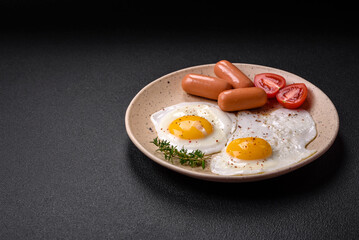 Fried chicken eggs, sausages, cherry tomatoes, chickpeas, spices, salt and herbs