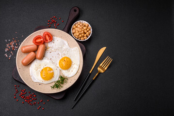 Fried chicken eggs, sausages, cherry tomatoes, chickpeas, spices, salt and herbs