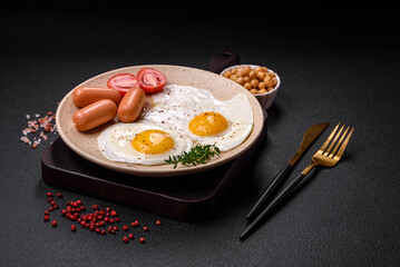 Fried chicken eggs, sausages, cherry tomatoes, chickpeas, spices, salt and herbs