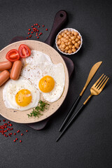 Fried chicken eggs, sausages, cherry tomatoes, chickpeas, spices, salt and herbs