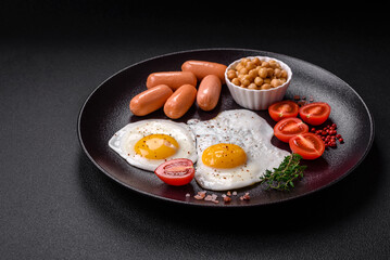 Fried chicken eggs, sausages, cherry tomatoes, chickpeas, spices, salt and herbs