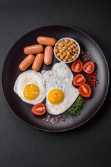 Fried chicken eggs, sausages, cherry tomatoes, chickpeas, spices, salt and herbs