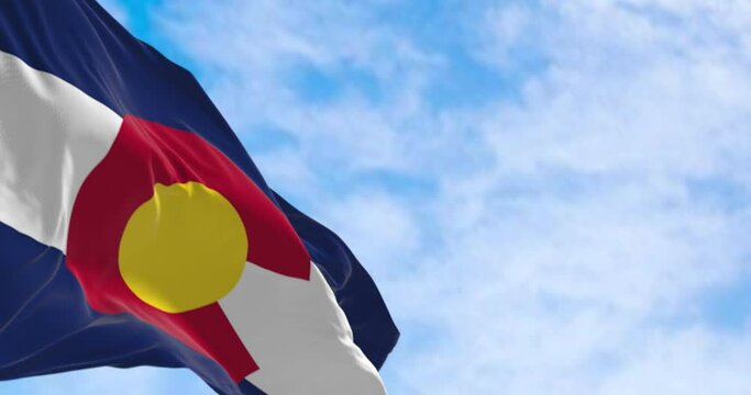 Close-up of Colorado state flag waving in the wind on a clear day