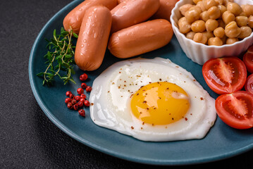 Fried chicken eggs, sausages, cherry tomatoes, chickpeas, spices, salt and herbs