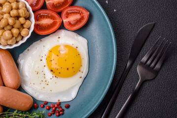 Fried chicken eggs, sausages, cherry tomatoes, chickpeas, spices, salt and herbs