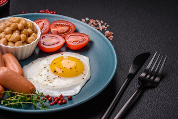 Fried chicken eggs, sausages, cherry tomatoes, chickpeas, spices, salt and herbs
