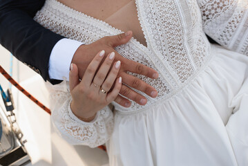 hands of a man and woman with rings on their wedding day