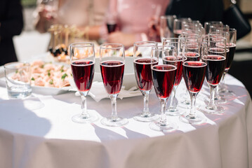 glasses with red wine on the buffet table at a wedding