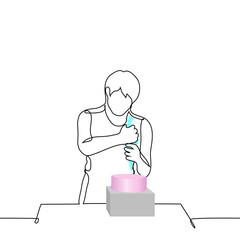 man stands holding culinary bag and squeezing cream out of it onto cake on stand in front of him - one line art vector. concept pastry chef, homemade cake, custom cake, preparation and decoration