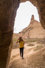 Woman strolling between rocky formations in a desert natural park