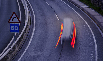 Traffic signs on the highway. Vehicle driving on the highway at night.