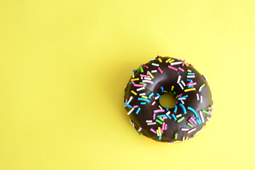 chocolate donut on yellow background copy space   