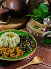 Green Rice or Nasi Daun Jeruk, the natural green colour of orange leaves is rich in nutrients. Served with shredded chicken and cassava leaf vegetables.