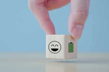 Hand holding happy smile face with full battery, Happiness, Full energy, Passion, Alertness, very...