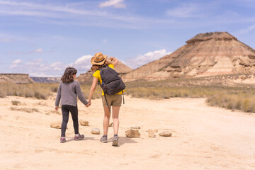 Mother and daughter walking in a desert in national park