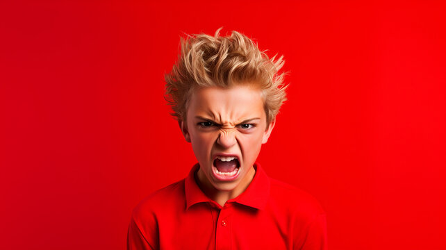 Angry irritated American boy on red background