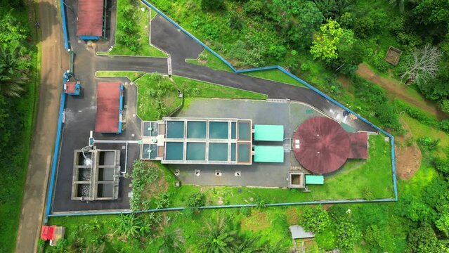 Descending over a water treatment facility, at Sao tome, Africa - Drone shot