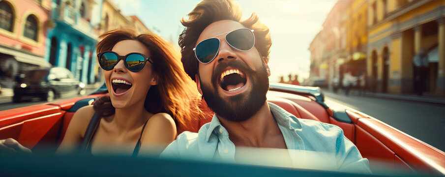 Happy young couple is enjoying ride in a cabriolet car during summer sunny day, active lifestyle concept
